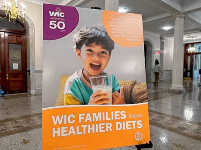 A poster celebrates the 50th anniversary of the Bay State's WIC program offering nutrition assistance to women, infants, and young children.