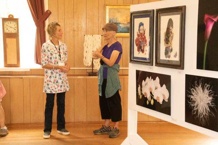 Artists and art enthusiasts peruse last year’s Heath Arts Exhibition.