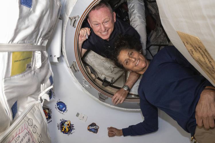 In this photo provided by NASA, Boeing Crew Flight Test astronauts Barry “Butch” Wilmore, left, and Sunita “Suni” Williams pose for a portrait inside the vestibule between the forward port on the International Space Station’s Harmony module and Boeing’s Starliner Calypso space capsule on June 13. What was supposed to be an eight-day trip will last closer to eight months due to technical issues with the Starliner.