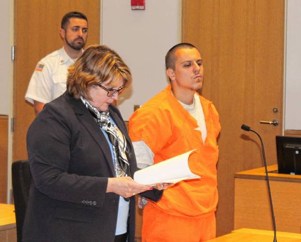 Gabe M. Adams, 21, stands next to defense attorney Nora Leovich before pleading guilty to 14 charges in Franklin County Superior Court on Wednesday afternoon.