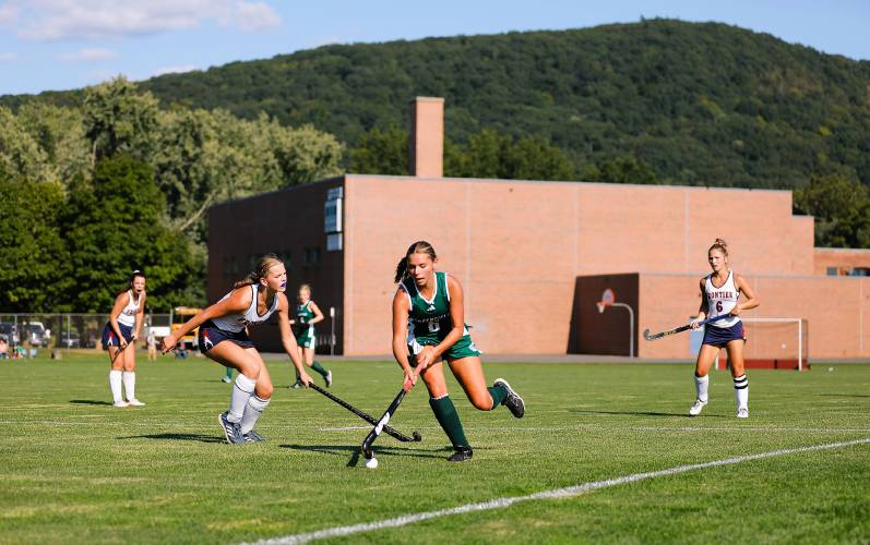 Greenfield’s Grace Laurie (6) carries the ball upfield past Frontier’s Elsa Brown (7) in the second quarter Wednesday in South Deerfield.