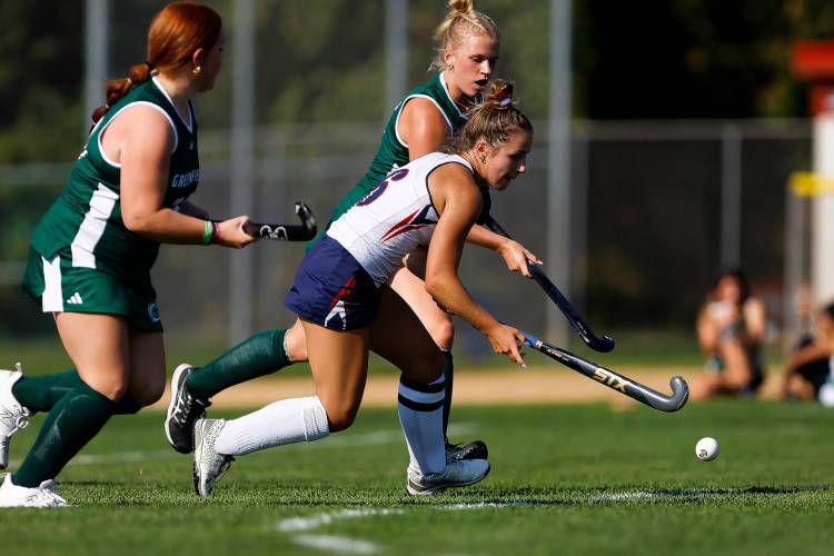 Frontier’s Ashley Taylor (6) carries the ball past Greenfield’s Olivia Lemay (29) and Gloria McDonald (5) in the first quarter Wednesday in South Deerfield.