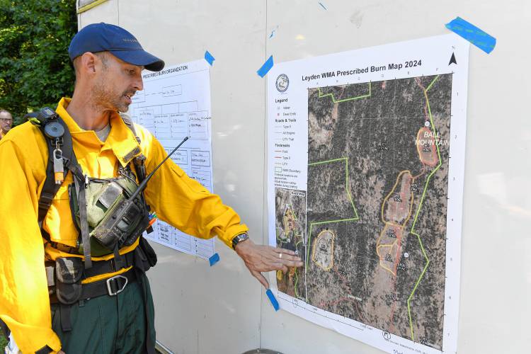 Alex Entrup, a prescribed fire and habitat restoration ecologist with MassWildlife, briefs the crew on the scope of a controlled burn in the Leyden Wildlife Management Areaon Wednesday.