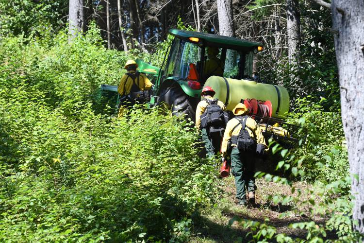 Personnel lay down a “wet line” of water using a tractor to establish a boundary on a controlled burn in the Leyden Wildlife Management Area by MassWildlife and other agencies on Wednesday.