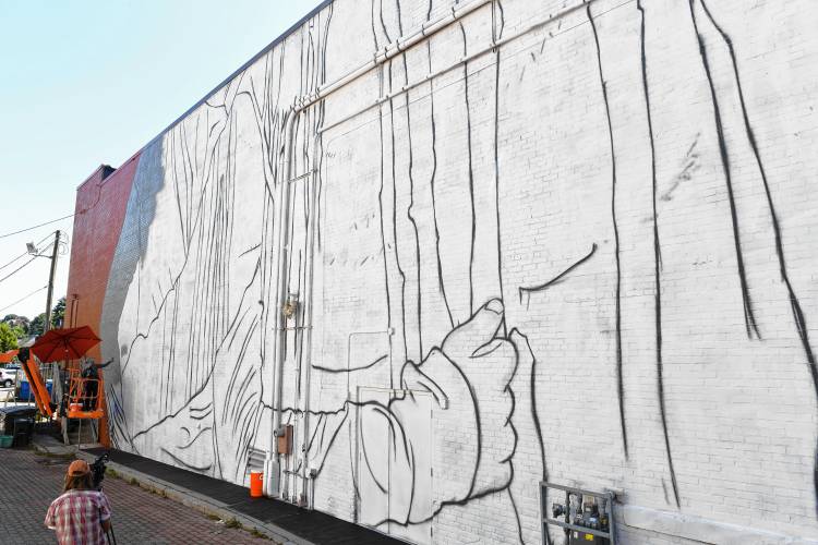 Muralist Darion Fleming of Charlotte, North Carolina, has started working on his mural on the side of the Shea Theater Arts Center in Turners Falls.