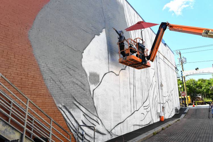 Muralist Darion Fleming of Charlotte, North Carolina, has started working on his mural on the side of the Shea Theater Arts Center in Turners Falls.