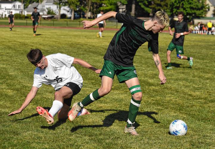 Greenfield’s Caleb Thomas, right, avoids  a tackle from Pioneer’s William Glazier during the teams’ 1-1 tie in Schmid Division opening action on Thursday in Greenfield. 