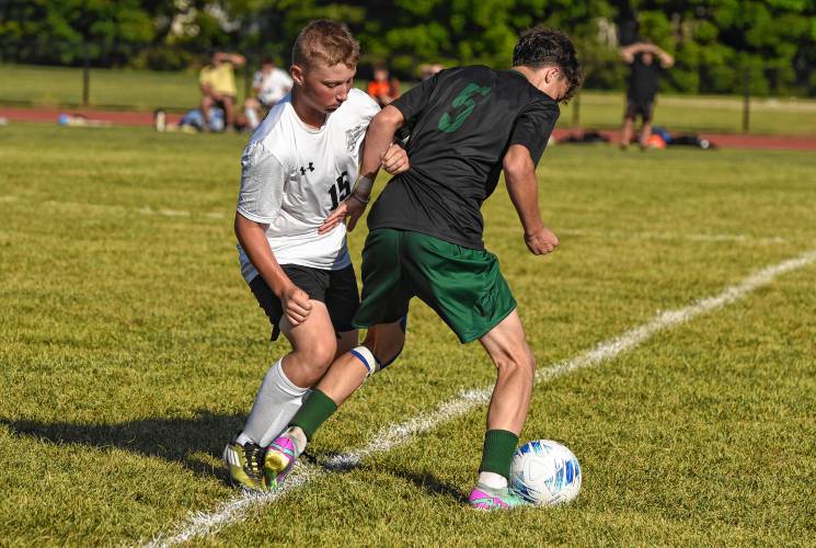 Pioneer’s Brody Welcome (15), left, defends Greenfield’s Nathan Gheorghita (5) during the teams’ 1-1 tie in Schmid Division opening action on Thursday in Greenfield.