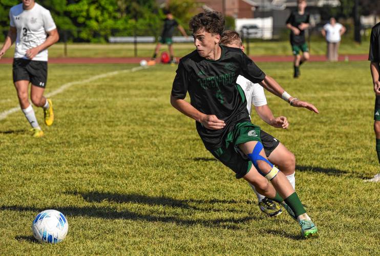 Greenfield’s Nathan Gheorghita carries the ball against Pioneer during the teams’ 1-1 tie in Schmid Division opening action on Thursday in Greenfield.