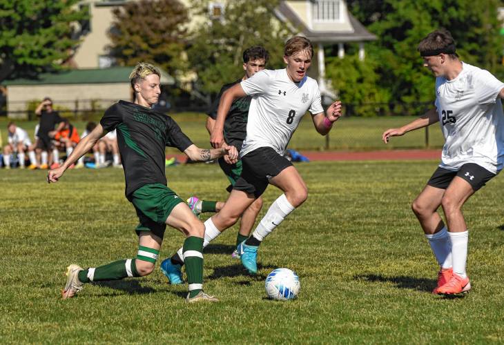 Greenfield’s Caleb Thomas tries to keep possession against Pioneer during the teams’ 1-1 tie in Schmid Division opening action on Thursday in Greenfield.