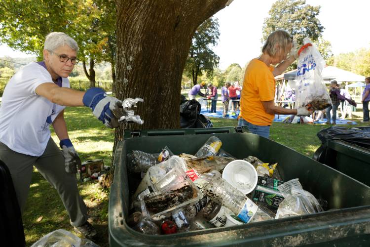 Volunteers Christine Turner, left, and Catherine Keppler work to sort through pieces for recycling brought to the Green River Swimming and Recreation Area as part of the 2019 Source to Sea Cleanup in Greenfield. The annual cleanup effort returns Sept. 28.