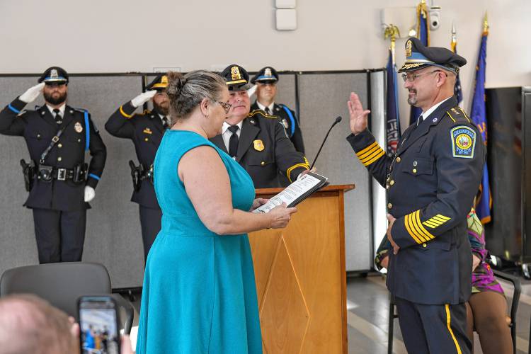 Greenfield City Clerk Kathy Scott swears in Todd Dodge as Greenfield’s permanent police chief during a ceremony at the John Zon Community Center on Tuesday evening.