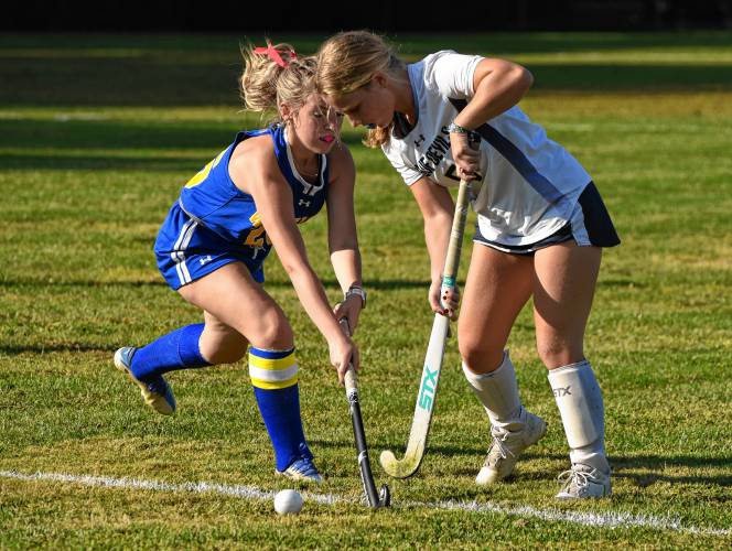 Mohawk Trail’s Jayda Waters, left, and Northampton’s Casey Barber battle for possession during Valley League field hockey action on Wednesday in Northampton.