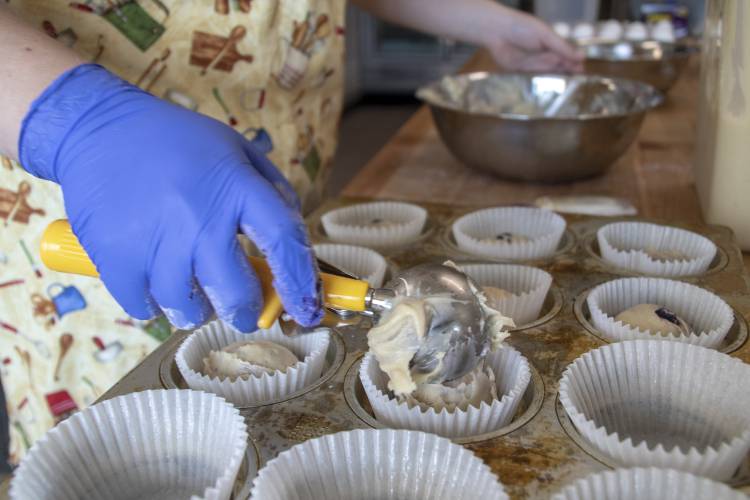 Laura Thiem, pictured here in 2018, puts a scoop of blueberry batter into a muffin tin at Bittersweet Bakery & Cafe in Deerfield. The business, which marked its six-year anniversary at the end of August, is temporarily closed as Thiem evaluates a new five-year plan.