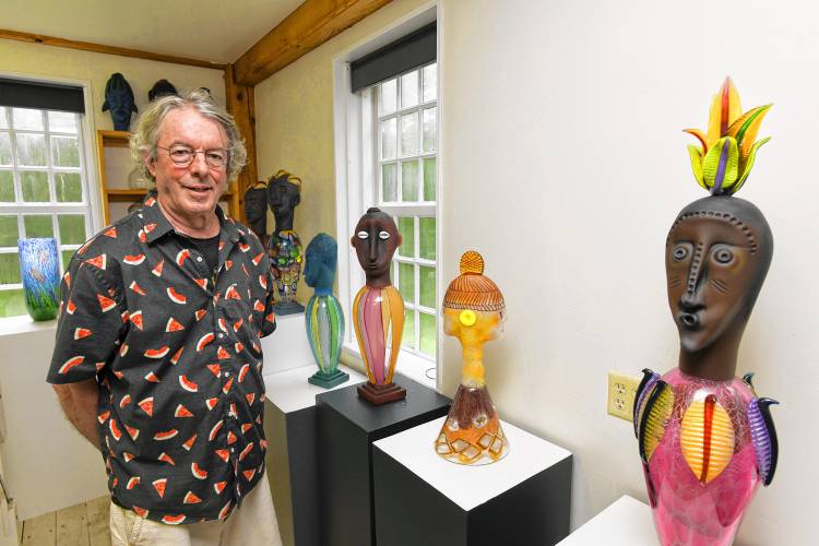 Robert Dane in his Heath studio with some of his work that is similar to what is featured in his exhibit, “Heartbeats and Harmony.”