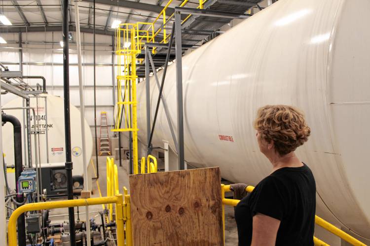 Northeast Biodiesel President Lynn Benander looks over equipment at her Silvio O. Conte Drive site in Greenfield before selling the start-up.