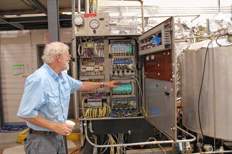 Northeast Biodiesel Operations Manager Brian Clark looks over equipment at the company’s Greenfield site.