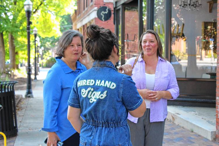 Signmaker Jess Marsh Wissemann, center, shows state Sen. Jo Comerford, left, and state Rep. Natalie Blais, right, signs she has made around Turners Falls on Friday. Marsh Wissemann is receiving the Outstanding Leadership Skills in Manufacturing Award.