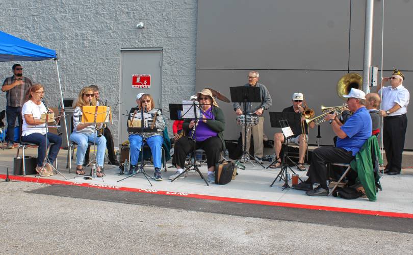 The Orange Community Band performs at a ceremony celebrating the remodel of the Orange Walmart Supercenter on Friday morning.