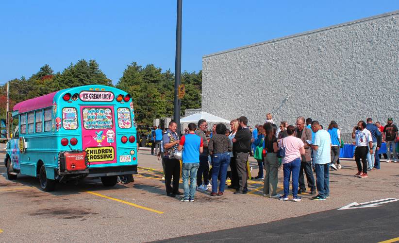 Attendees and an ice cream truck at a ceremony celebrating the remodel of the Orange Walmart Supercenter on Friday morning.