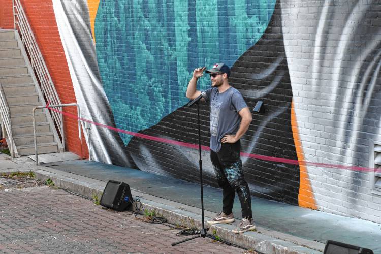 North Carolina muralist Darion Fleming speaks about his creation on the side of the Shea Theater Arts Center in Turners Falls on Saturday afternoon.