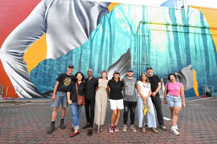 Those who played a role in creating the mural on the Shea Theater Arts Center in Turners Falls pose for a photo Saturday afternoon. 