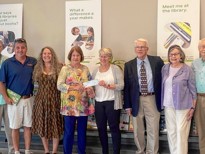 Greenfield Public Library Foundation members present Mayor Ginny Desorgher with a check for $250,000 on Monday, finalizing the foundation’s $2 million pledge to help fund the library’s construction.