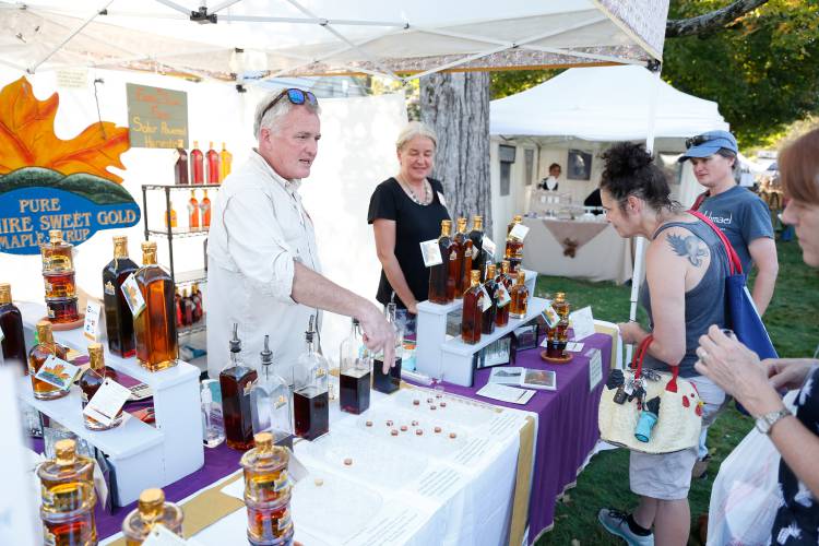 Brooks McCutchen, left, and Janis Steele talk with customers about their maple products at the Old Deerfield Fall Arts and Crafts Festival in 2019. The 48th annual event returns on Saturday, Sept. 21, and Sunday, Sept. 22.