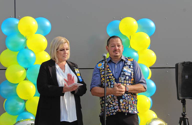 Tammi Cadieux, manager of the Orange Walmart Supercenter, and Chad Stanton, senior manager of Realty Project Management at Walmart Inc., speak at a ceremony celebrating its remodel on Friday morning.