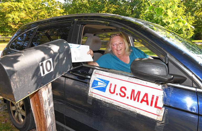 Wendy Flanders, delivering mail in New Salem, is retiring after 40 years.