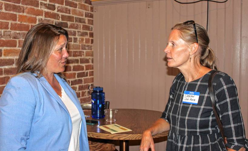 State Rep. Natalie Blais, D-Deerfield, left, and Sarah Tanner, interim executive director of Just Roots, chat during a summit for area nonprofits held at Hawks & Reed Performing Arts Center’s Grand Ballroom on Tuesday afternoon. The summit focused on efforts to enhance the services provided to the community and how the organizations can approach operations more strategically.