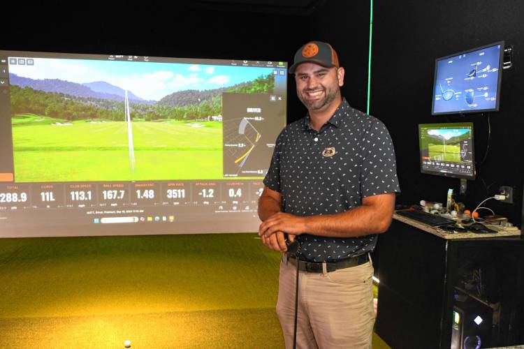 Matt Bardsley in the Birdie Train Golf Lounge simulator located at the Boiler Bar & Grille in Orange.