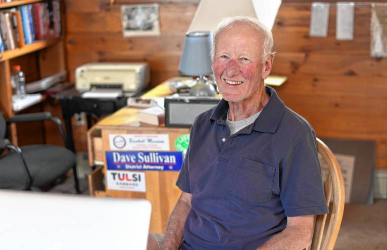 Chip Ainsworth sits at his desk in his Northfield home. Eight years ago he was diagnosed with prostate cancer and underwent treatment. Today, his levels “negligible,” his energy is good, and he walks seven miles a day.