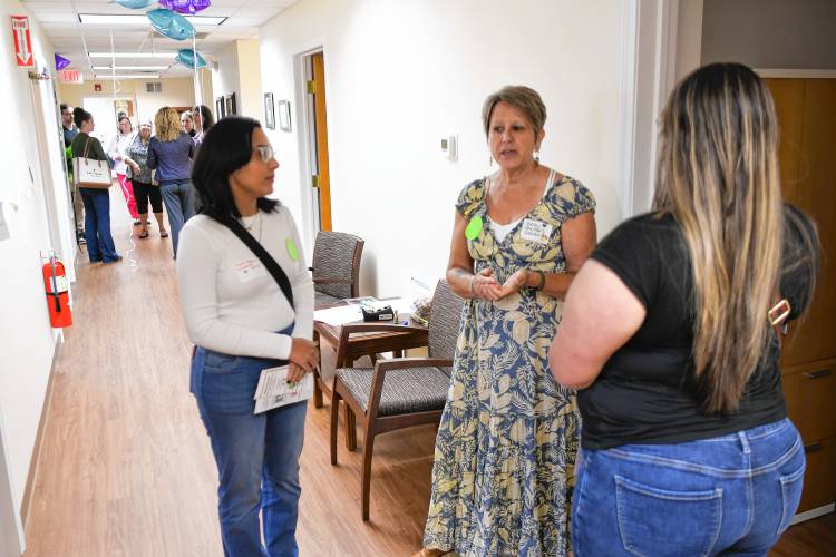 Salasin Project Director Becky Lockwood, center, talks with Krysta Pacheco and Tamicha Colon during an open house at its 33 Riddell St. location in Greenfield on Wednesday.