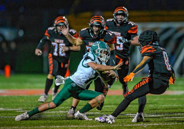 Greenfield’s Caleb Murray is stopped by the South Hadley defense during the first half at South Hadley on Friday.