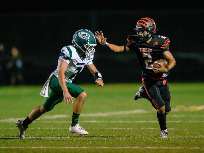 Greenfield’s Caleb Murray, left, attempts to tackle South Hadley’s Julius Hebenth during the first half at South Hadley on Friday.