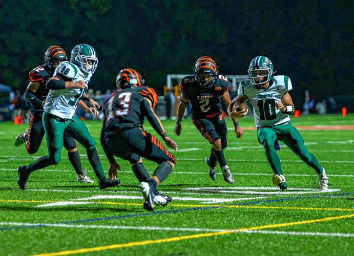 Greenfield’s Mason Cummings, right, carries the ball against South Hadley during the first half of their high school football game at South Hadley on Friday.