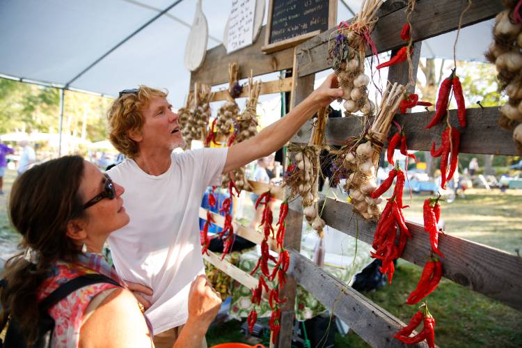 Jon Holland and Lisa Bouchie, of Orange, pick out handmade garlic braids for sale during the 2017 North Quabbin Garlic and Arts Festival in Orange. The 26th rendition of the event is set for Saturday, Sept. 28, and Sunday, Sept. 29.