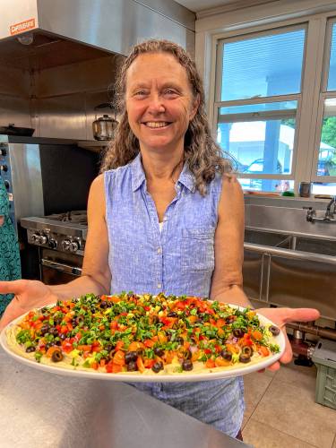 Daphne chops the vegetables for the hummus very finely. She even quarters her cherry tomatoes, which can’t be easy to do. The result is that each bite of hummus brings with it several different vegetable flavors, embodying the produce of late summer and early fall.