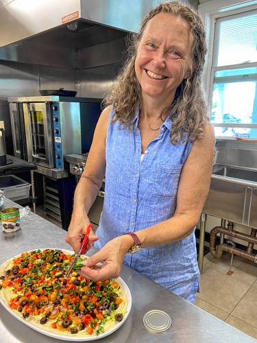 Daphne chops the vegetables for the hummus very finely. She even quarters her cherry tomatoes, which can’t be easy to do. The result is that each bite of hummus brings with it several different vegetable flavors, embodying the produce of late summer and early fall.