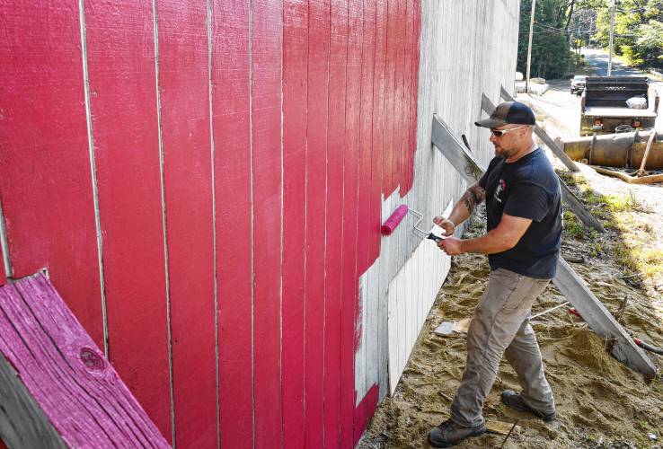 New Salem Highway Department employee Hayden Kanash paints the salt shed on a recent morning.