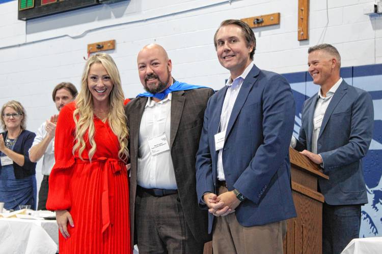 Franklin County Chamber of Commerce Executive Director Jessye Deane, Gagne Wealth Management founder Merrill Gagne and Children’s Advocacy Center Executive Director Jeff Trant pose for a photo as Gagne was honored at the Chamber of Commerce’s “Super Chamber Breakfast” on Friday at Franklin County Technical School.