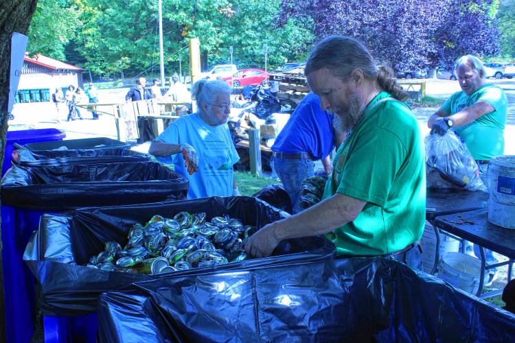 Philip Coolbeth and his mother, Pat Spinelli, sort recyclables collected near the Green River Swimming and Recreation Area in Greenfield during the 28th annual Source to Sea Cleanup on Saturday.