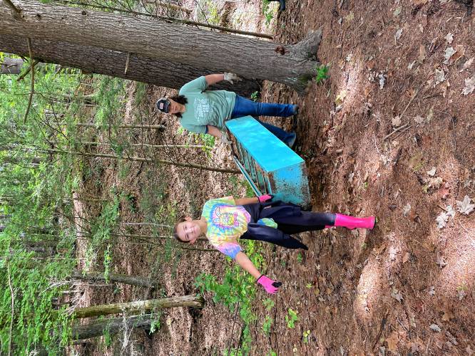 Gwen Stone and Cindy Pease of Girl Scout Troop 64980 participate in a cleanup effort on Eunice Williams Drive in Greenfield on Saturday.