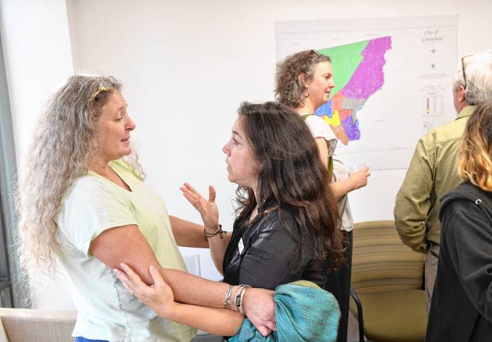 Rachel Roberts embraces Hannah Rechtschaffen, director of the Greenfield Business Association, congratulating her on the GBA’s new space at 278 Main St., Suite 204, in Greenfield during an open house on Friday.