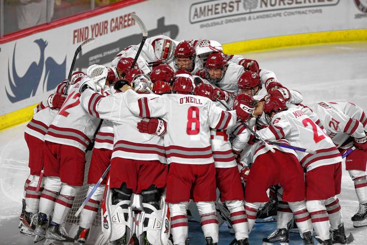 UMass players huddle up prior to their season opener against AIC last season at the Mullins Center in Amherst.