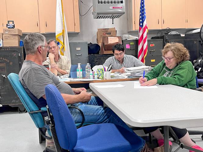 Hawley Selectboard members Bob MacLean, Will Cosby and Hussain Hamdan discuss town clerk needs with Administrative Assistant Tinky Weisblat on Thursday.