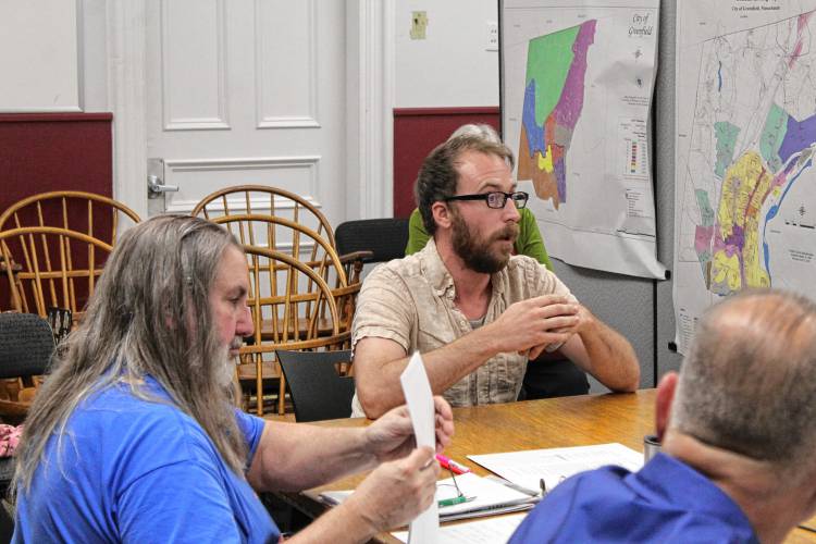 At-Large City Councilor John Garrett discusses a series of proposed zoning amendments with Greenfield Planning Board members on Thursday.