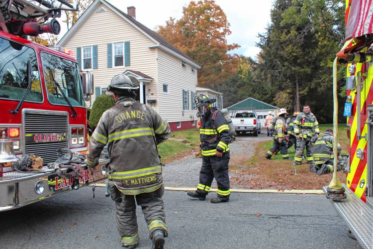 Firefighters respond to a Burrill Avenue home in Orange to extinguish a basement fire on Tuesday.