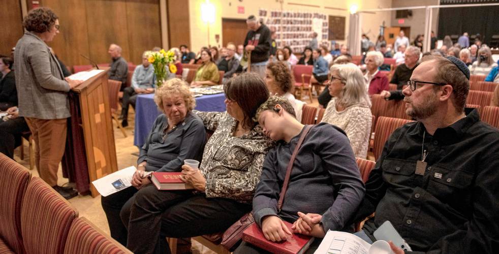 Sari Fein reads names of those who died in the Hamas attack against Israel of Oct. 7, 2023, at a commemoration Monday at Congregation B’nai Israel in Northampton as Henia Lewin, Leah Finch, Alex Carter-Ray, Emil Ray and Ronny Almog listen. 